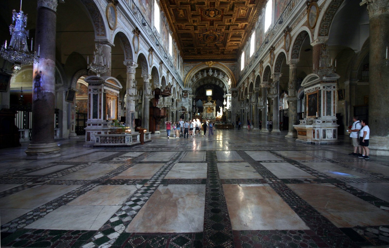 Central nave of the Basilica of Santa Maria in Ara Coeli with antique columns, Cosmatesque floor and gilded coffered ceiling