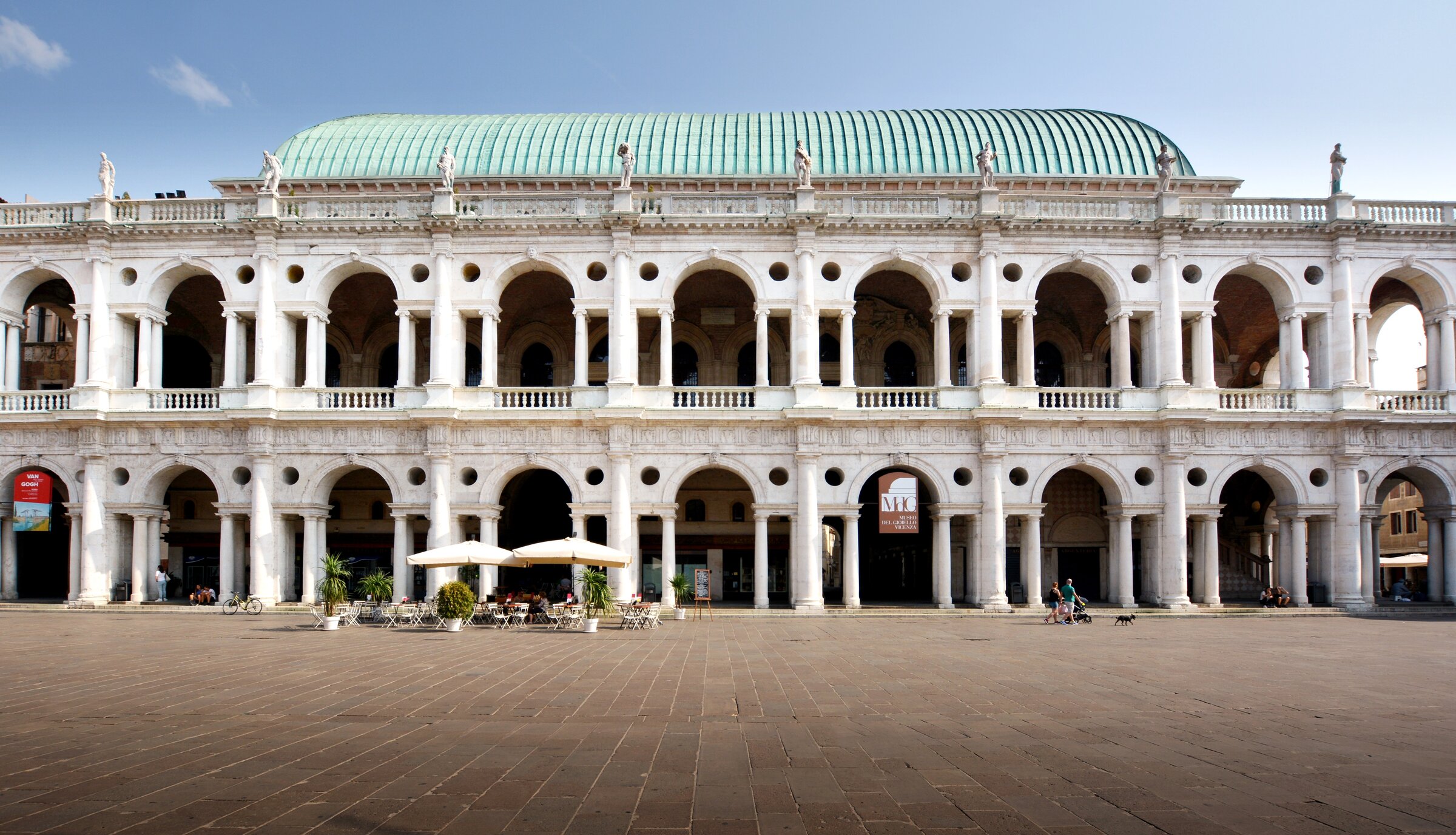 Side view of the Palladian Basilica in summer light, showing the long flank and copper roof