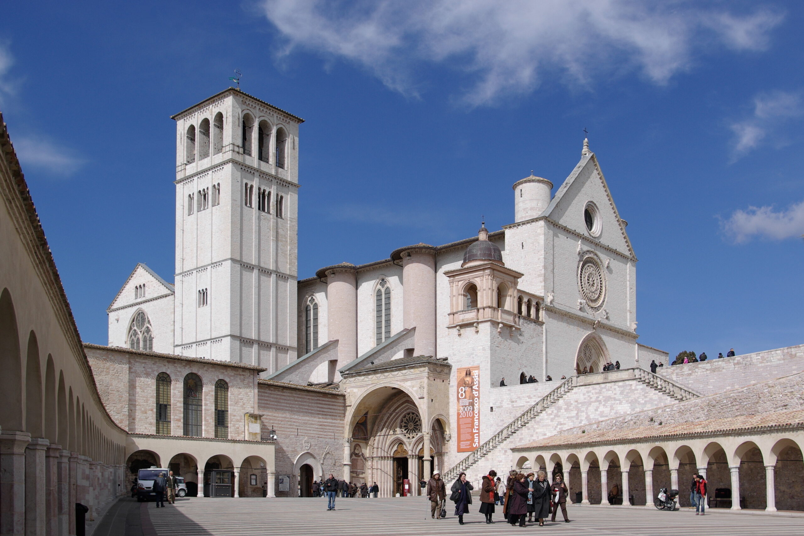 Facade and bell tower of the Basilica of Saint Francis of Assisi seen from the upper piazza