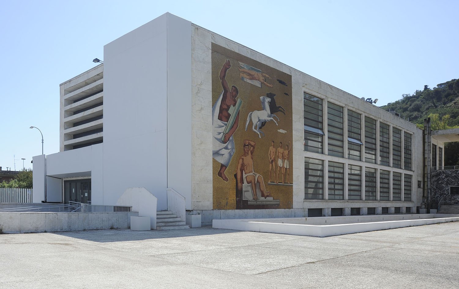 White marble facade of the Casa delle Armi by Luigi Moretti at the Foro Italico in Rome, photographed in 2021