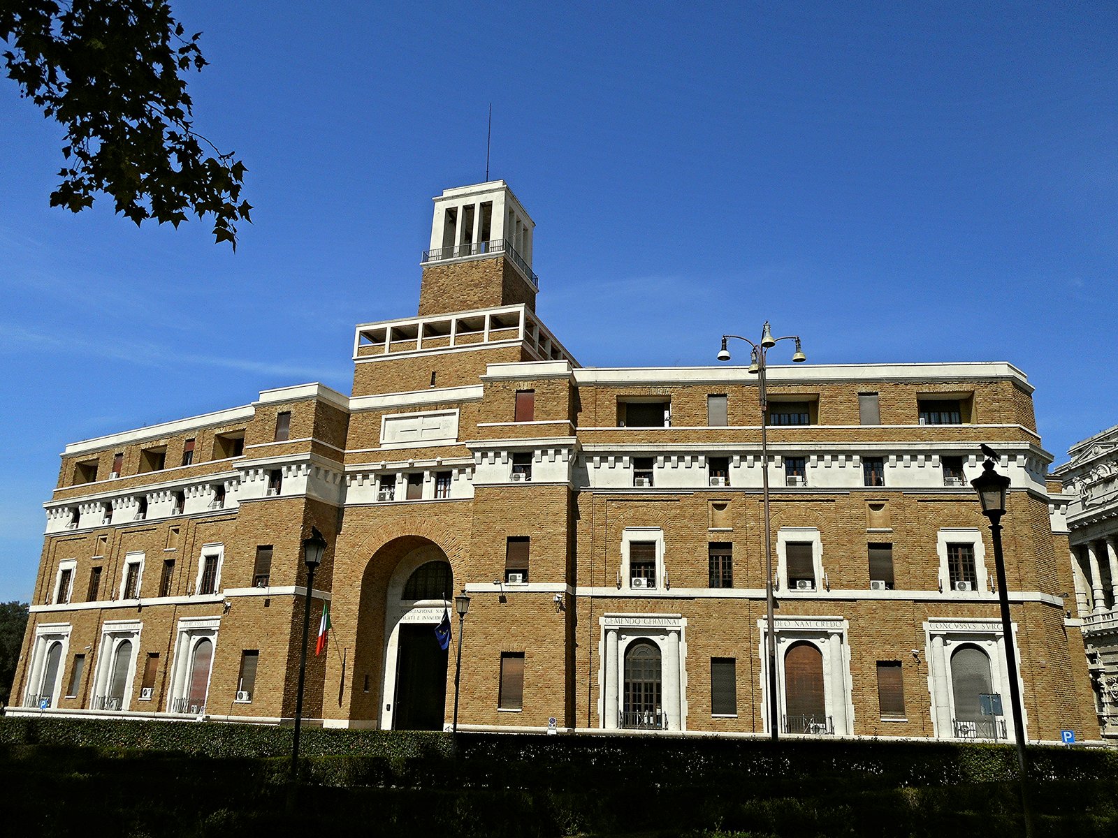 Travertine and brick facade of the Casa Madre dei Mutilati in Rome, designed by Marcello Piacentini, seen from Piazza Adriana near Castel Sant'Angelo