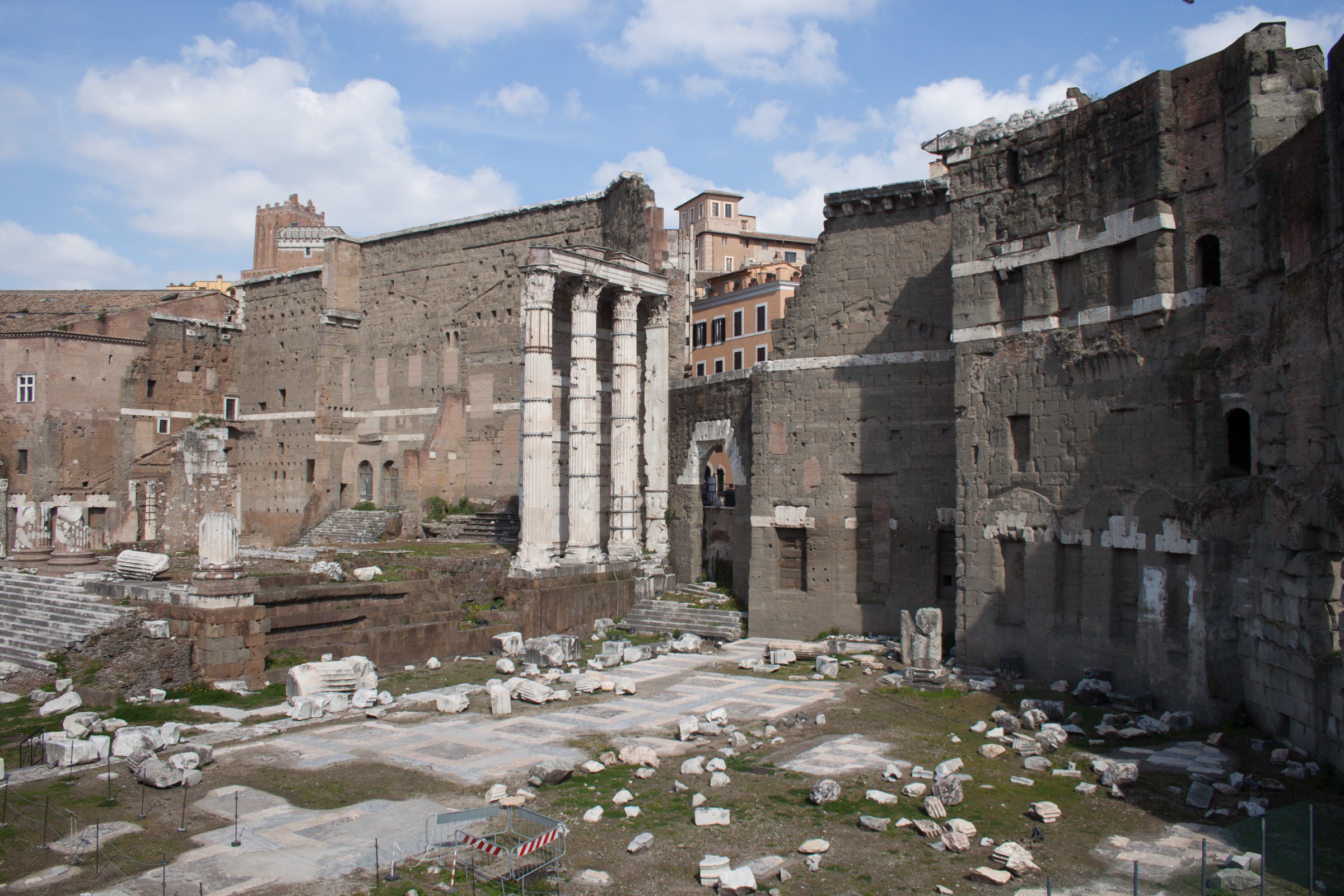 Surviving columns and high tufa firebreak wall of the Temple of Mars Ultor in the Forum of Augustus, Rome