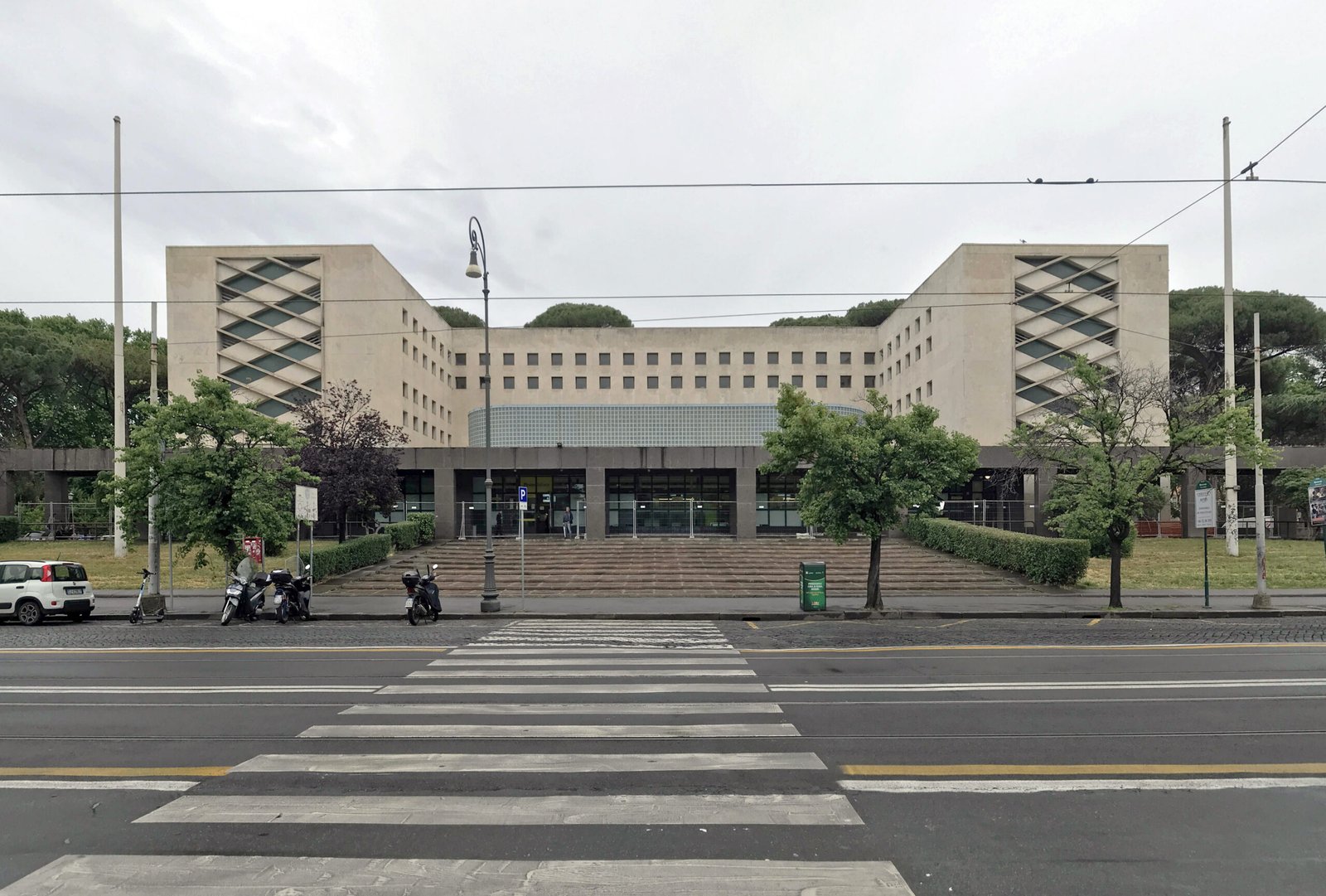 Long horizontal travertine facade of the Palazzo delle Poste, Via Marmorata, Rome, photographed in 2024
