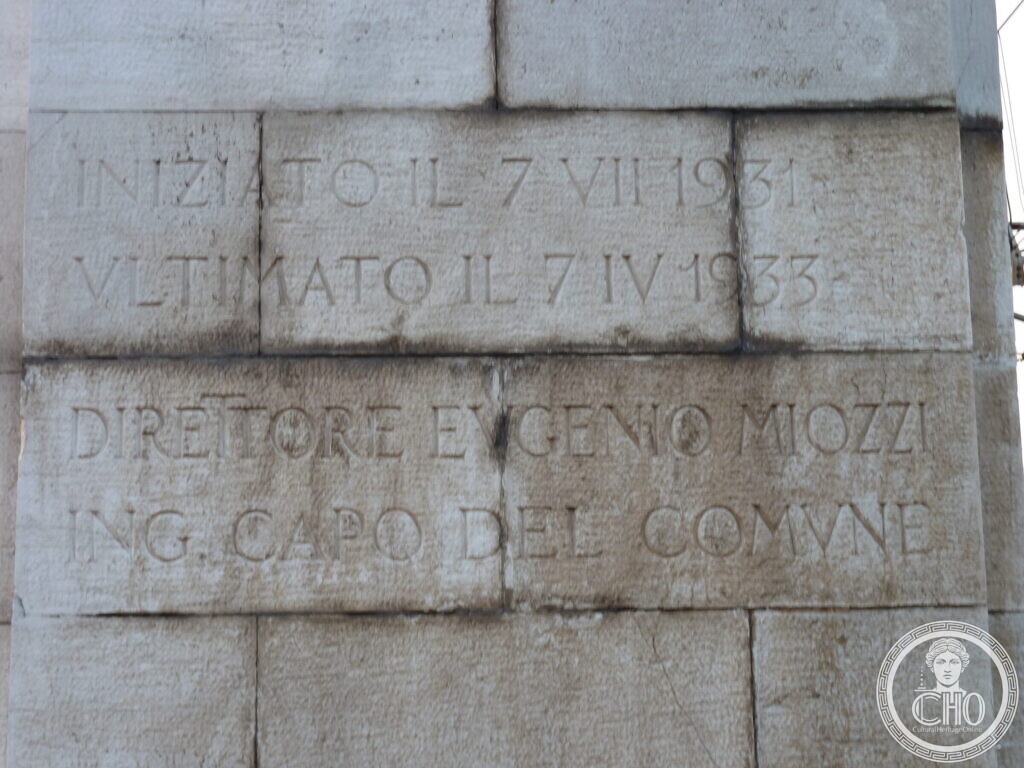 Stone blocks carved with the inscription recording that the bridge was begun on 7 July 1931 and completed on 7 April 1933 under engineer Eugenio Miozzi