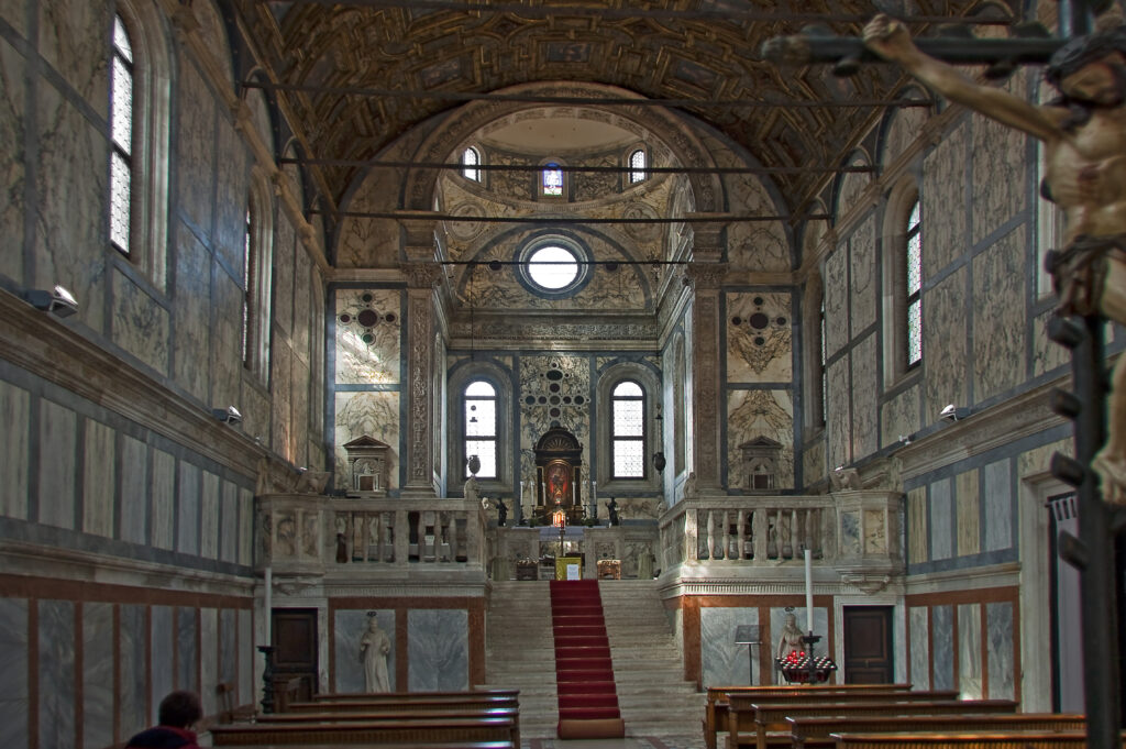 Interior of Santa Maria dei Miracoli, Venice — barrel-vaulted nave and marble stair