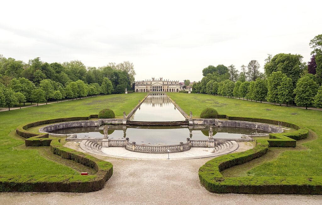 The park of Villa Pisani seen from the stables, the peschiera and its hedges leading back to the villa