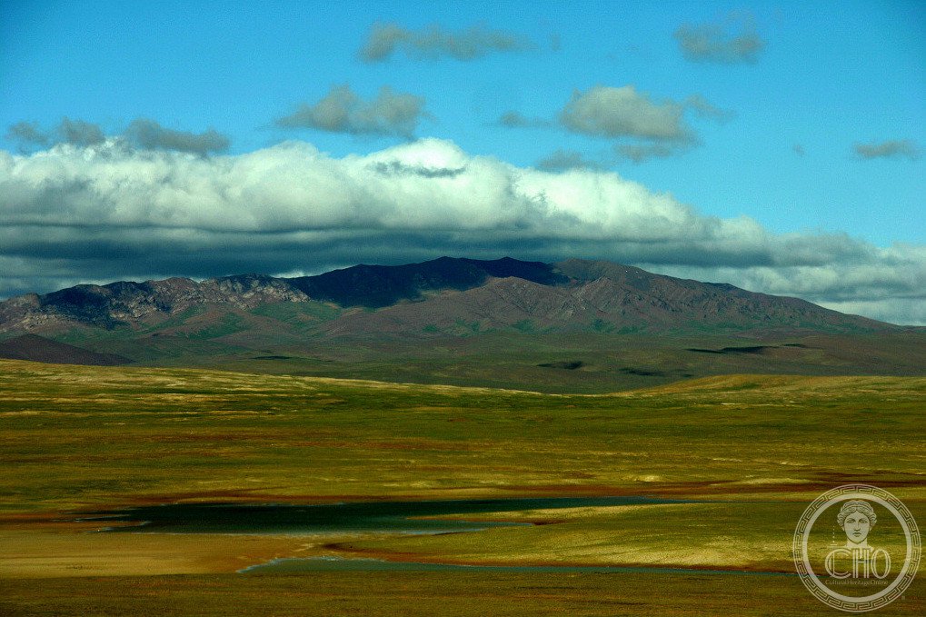 Vast open plateau landscape of Hoh Xil (Kekexili) in Qinghai, China — rolling tundra, frozen ground and distant peaks under a wide sky