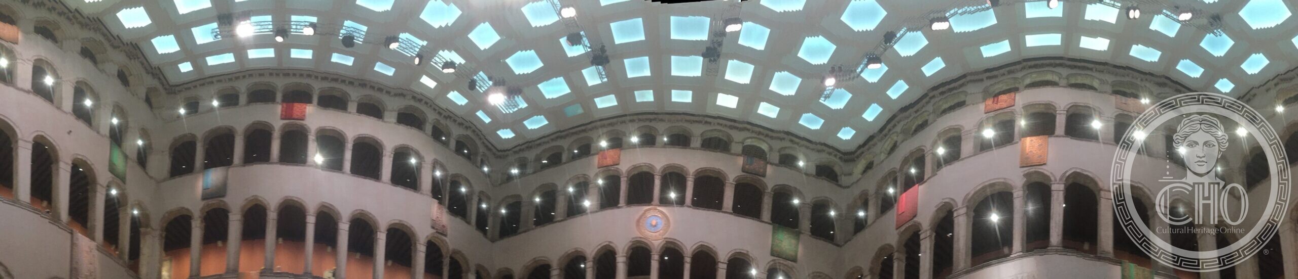 A 360-degree panorama of the glass-roofed inner courtyard of the Fondaco dei Tedeschi, Venice, with its tiered arcades
