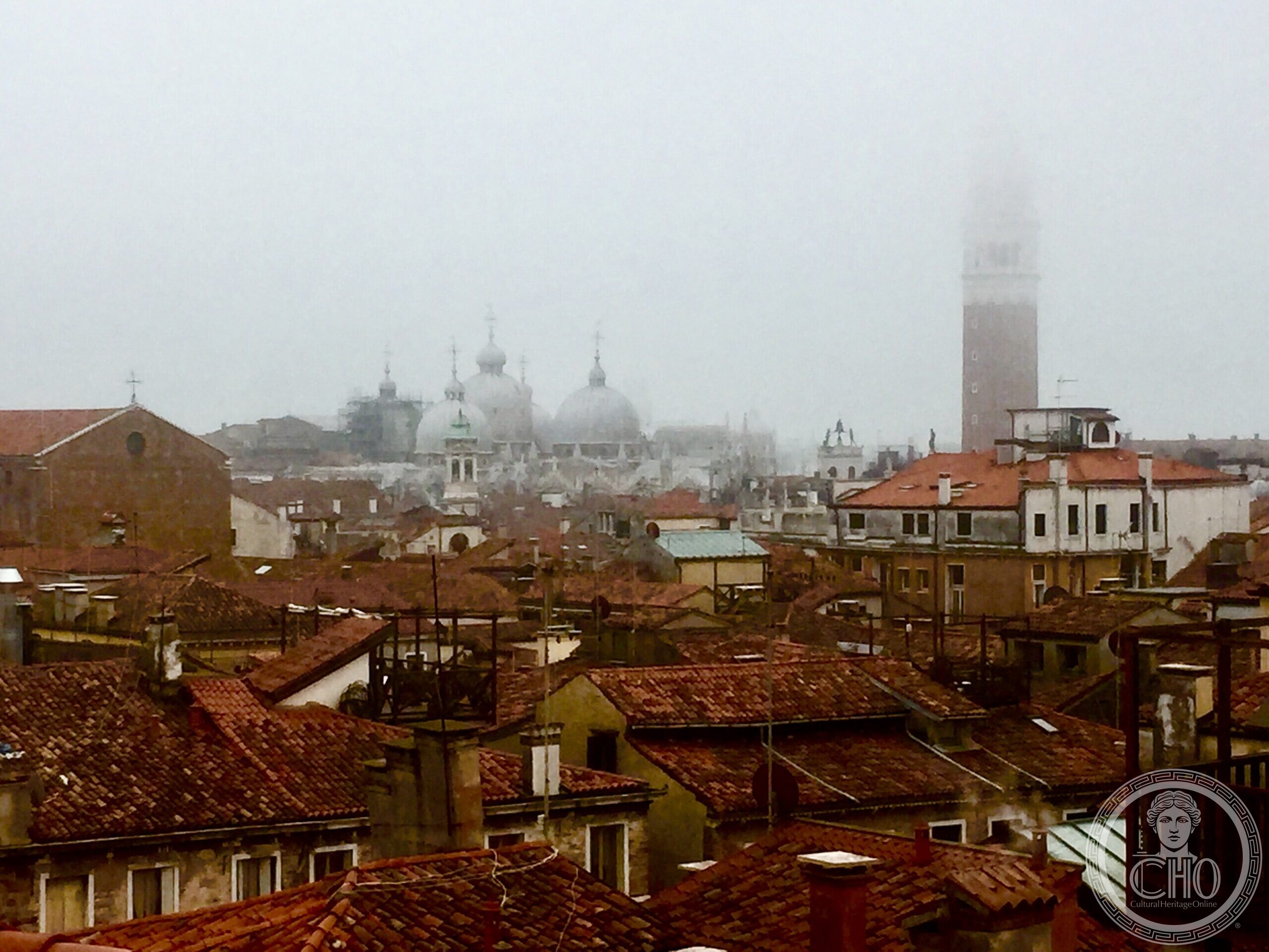 The domes of St Mark's Basilica and its campanile seen in fog from the Fondaco dei Tedeschi terrace