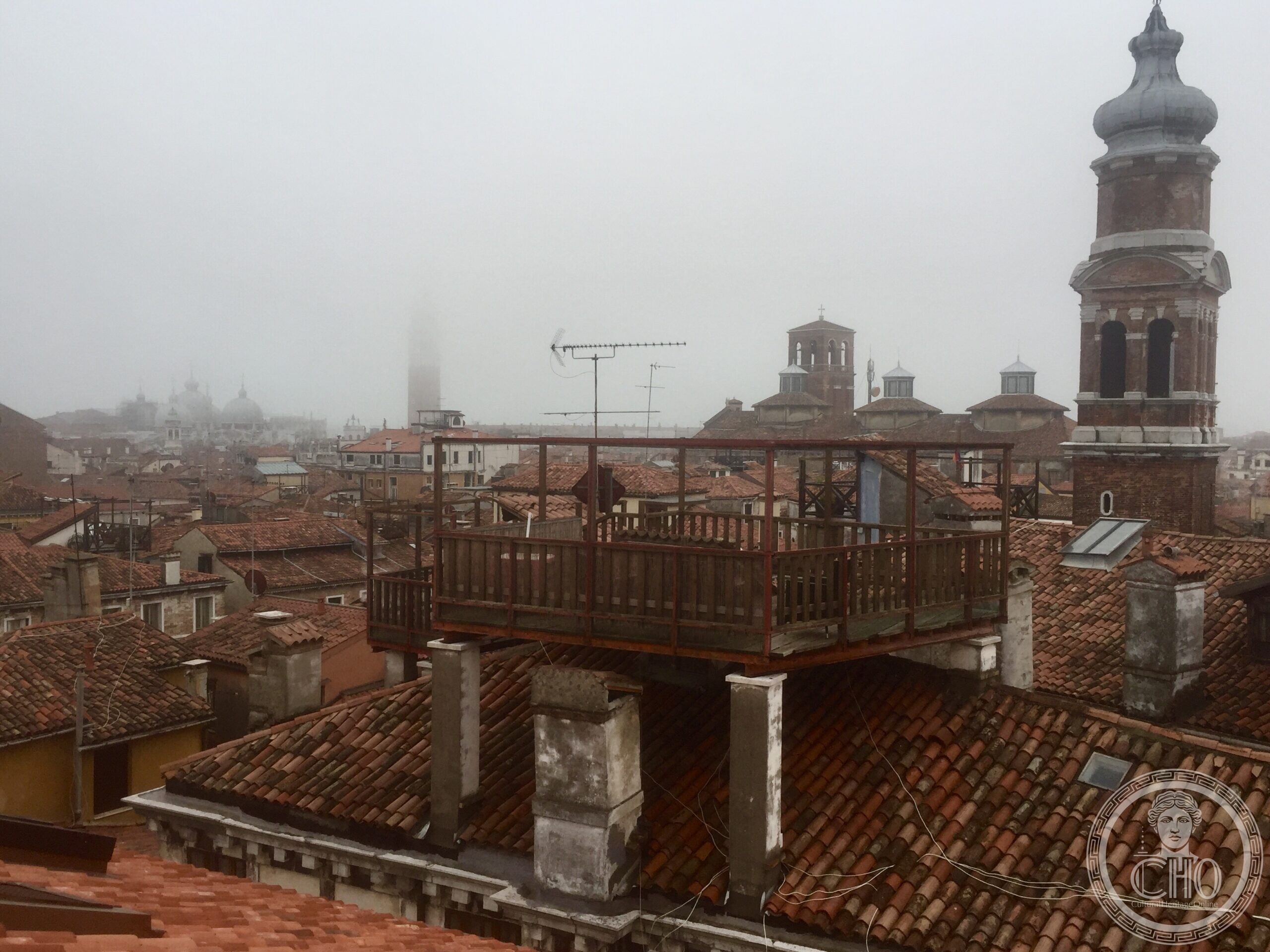 A rooftop terrace and bell tower seen from the Fondaco dei Tedeschi terrace