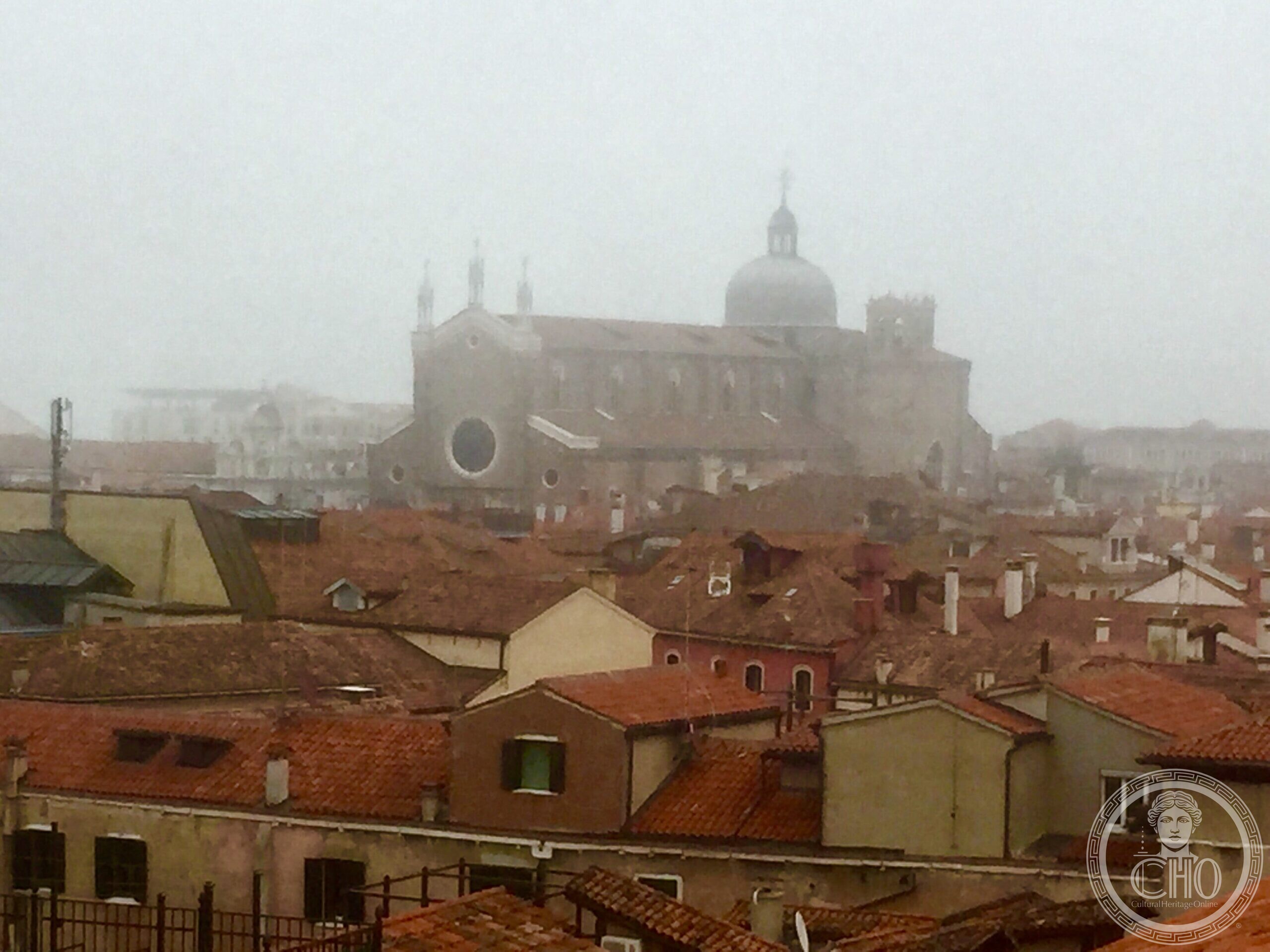 A Venetian church seen across the rooftops in fog from the Fondaco dei Tedeschi terrace