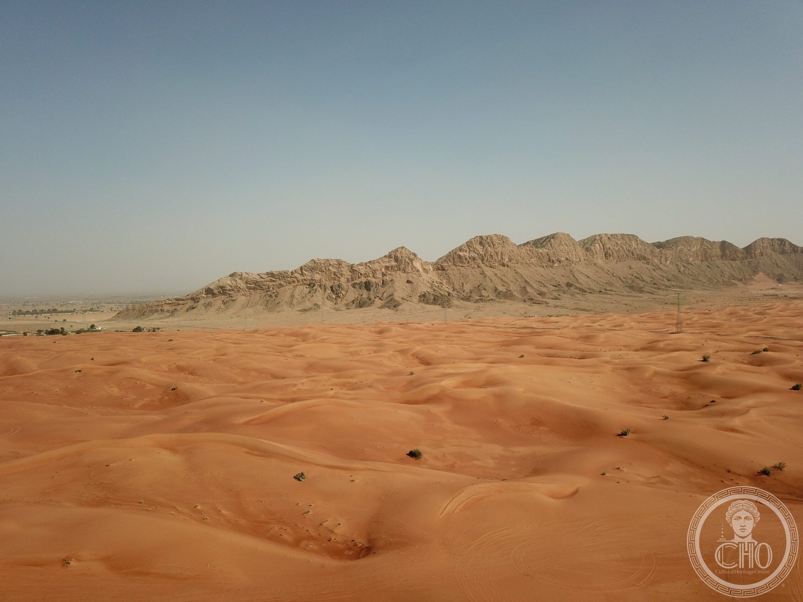 Jebel Faya (Jabal Al Fayah) rock formation in the Emirate of Sharjah, UAE — this isolated sandstone massif sheltered early Homo sapiens during the Out of Africa dispersal 125,000 years ago; stone tools found here predate any other human presence in Arabia