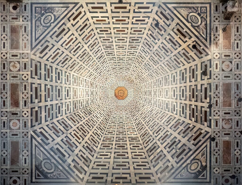 The inlaid marble floor of the cathedral, whose pattern reads as a relief