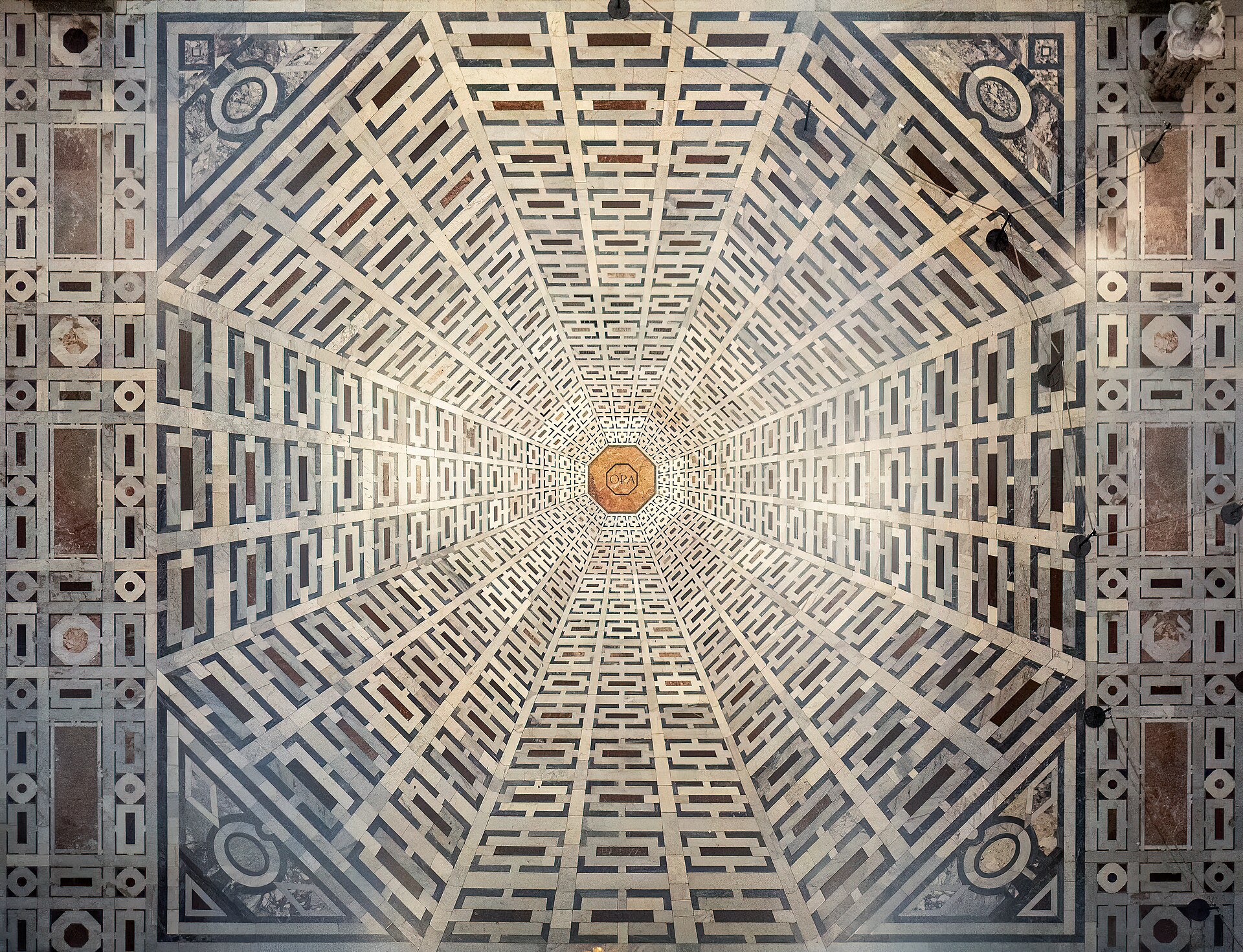 The inlaid marble floor of the cathedral, whose pattern reads as a relief
