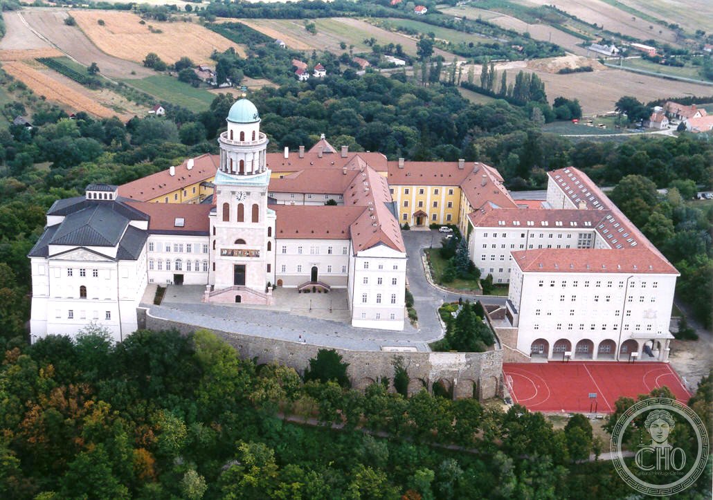 Pannonhalma Archabbey, the thousand-year-old Benedictine monastery crowning Sacred Hill in western Hungary — medieval towers and cloisters above the Pannonian Plain