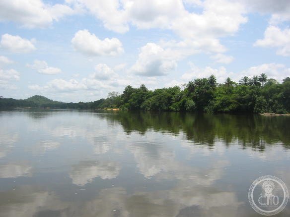 Crossing the Moa River at Tiwai Island Wildlife Sanctuary in Sierra Leone — the Gola-Tiwai complex spans the Sierra Leone-Liberia border and protects one of the largest remaining fragments of Upper Guinea forest, home to chimpanzees, pygmy hippopotamus and the extremely rare white-necked picathartes