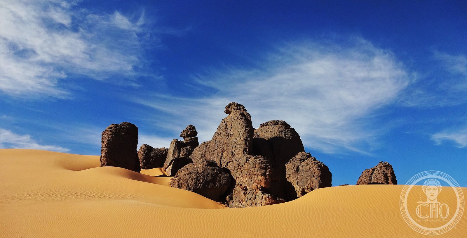 Ancient sandstone formations and eroded rock plateaux of Tassili n'Ajjer in the Algerian Sahara, a high orange desert landscape