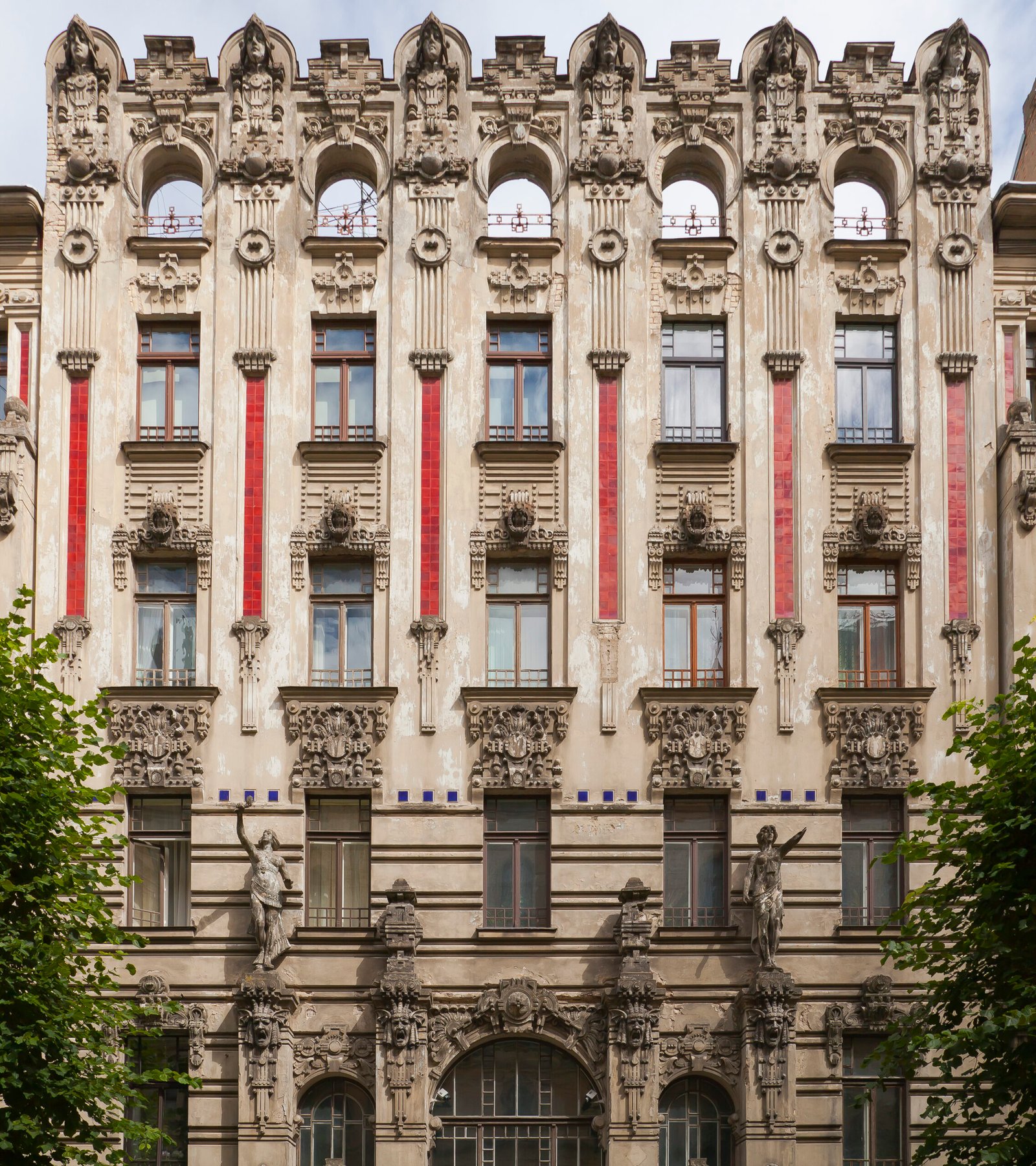 Ornate Art Nouveau apartment facade on Alberta iela in Riga with masks, figures and floral relief