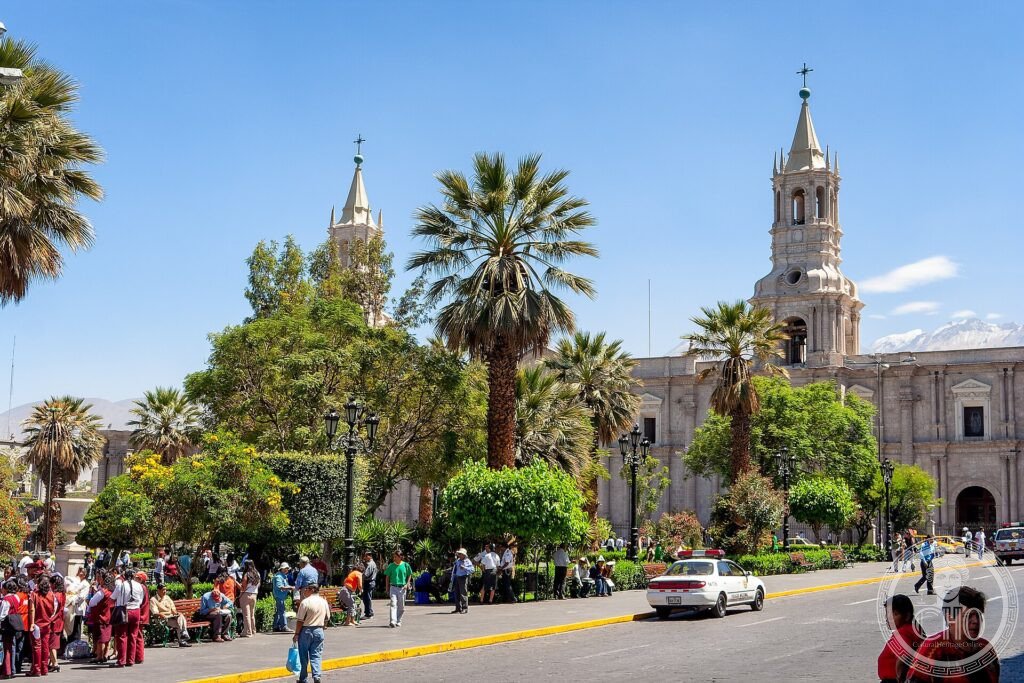 The white sillar-stone cathedral on the Plaza de Armas of Arequipa beneath a volcano