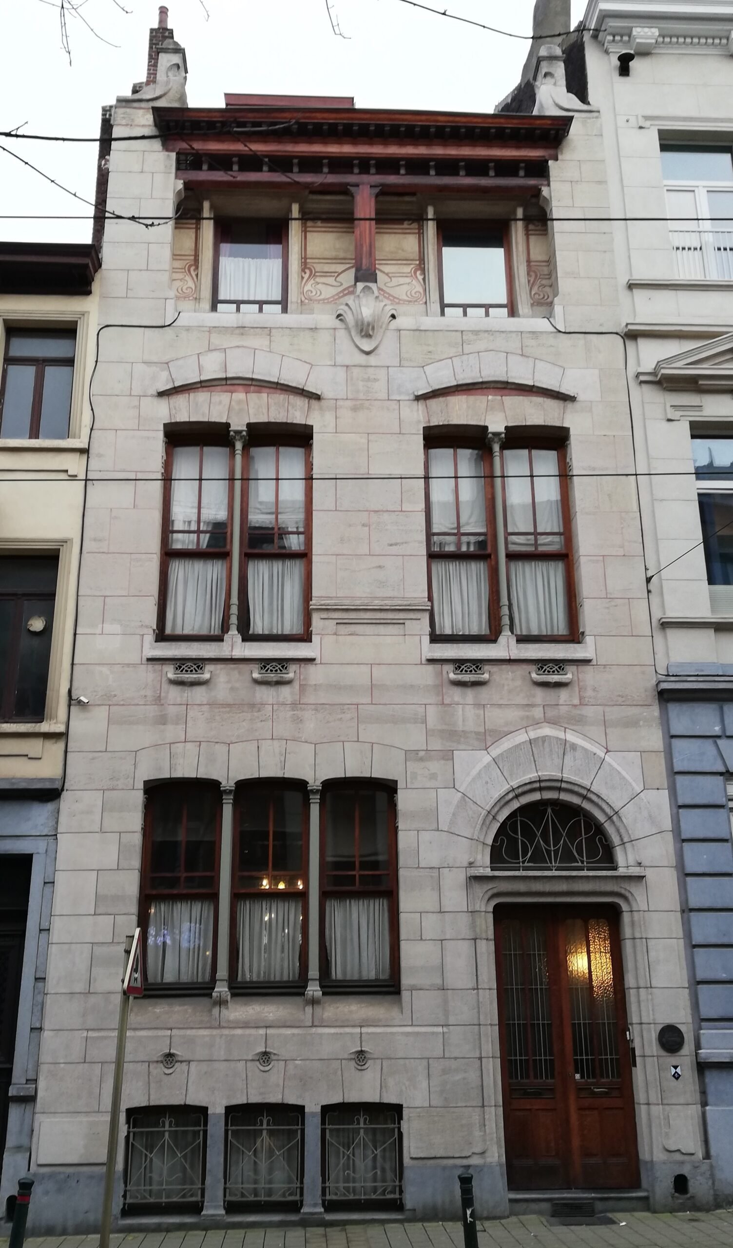 Art Nouveau stone-and-brick street facade of Maison Autrique in Schaerbeek, Brussels