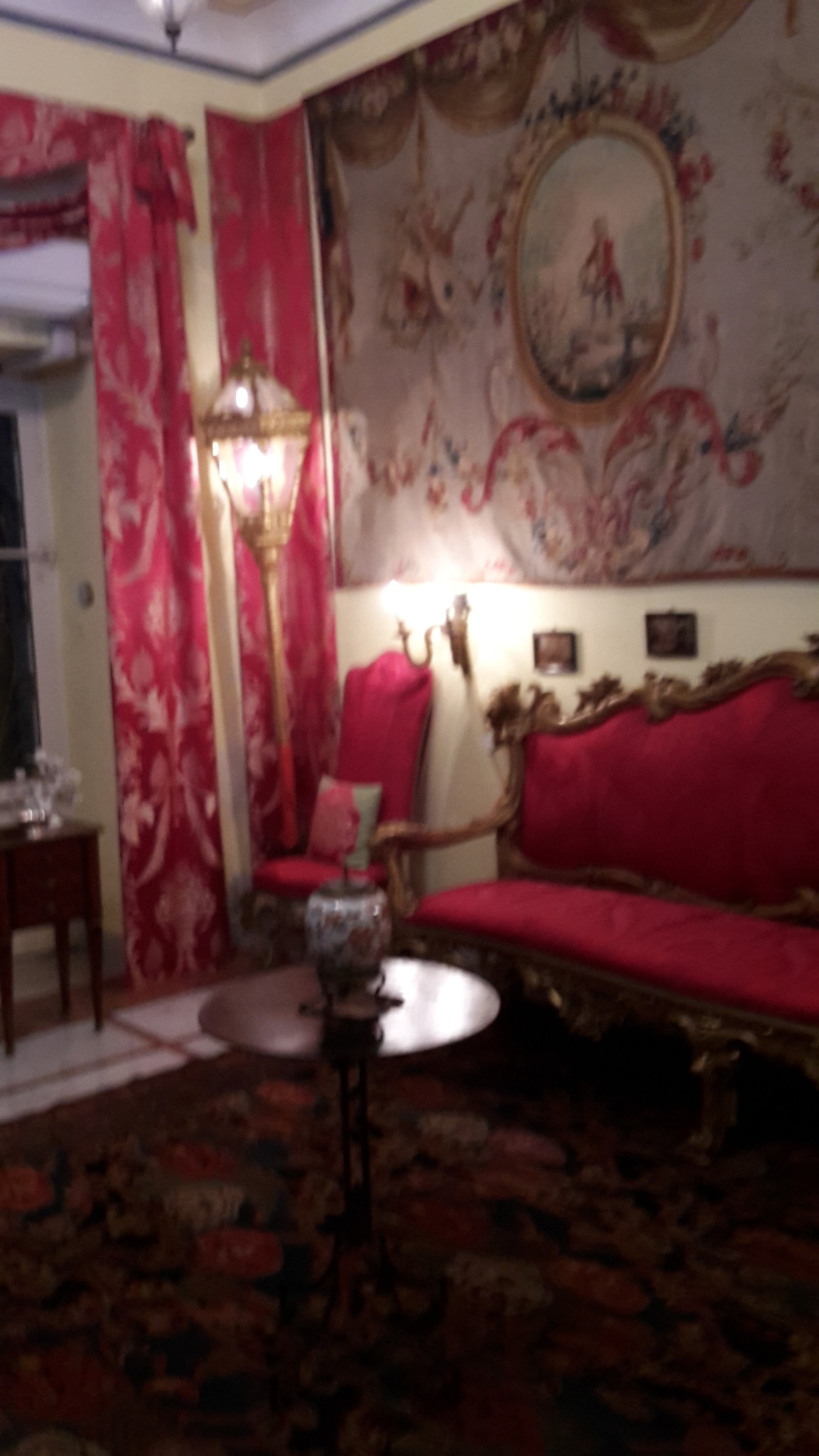 Casa e Collezione Laura — the red salon hung with antiques and porcelain, Ospedaletti, Ligurian Riviera