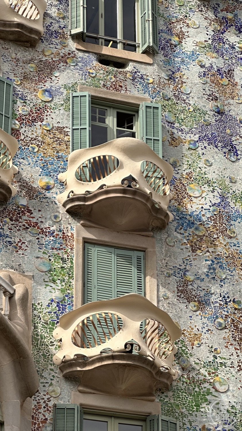 Casa Batlló — The undulating stone columns and trencadís mosaic in detail.