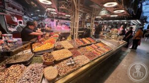 La Boqueria — Dried fruit and nuts heaped at a counter.
