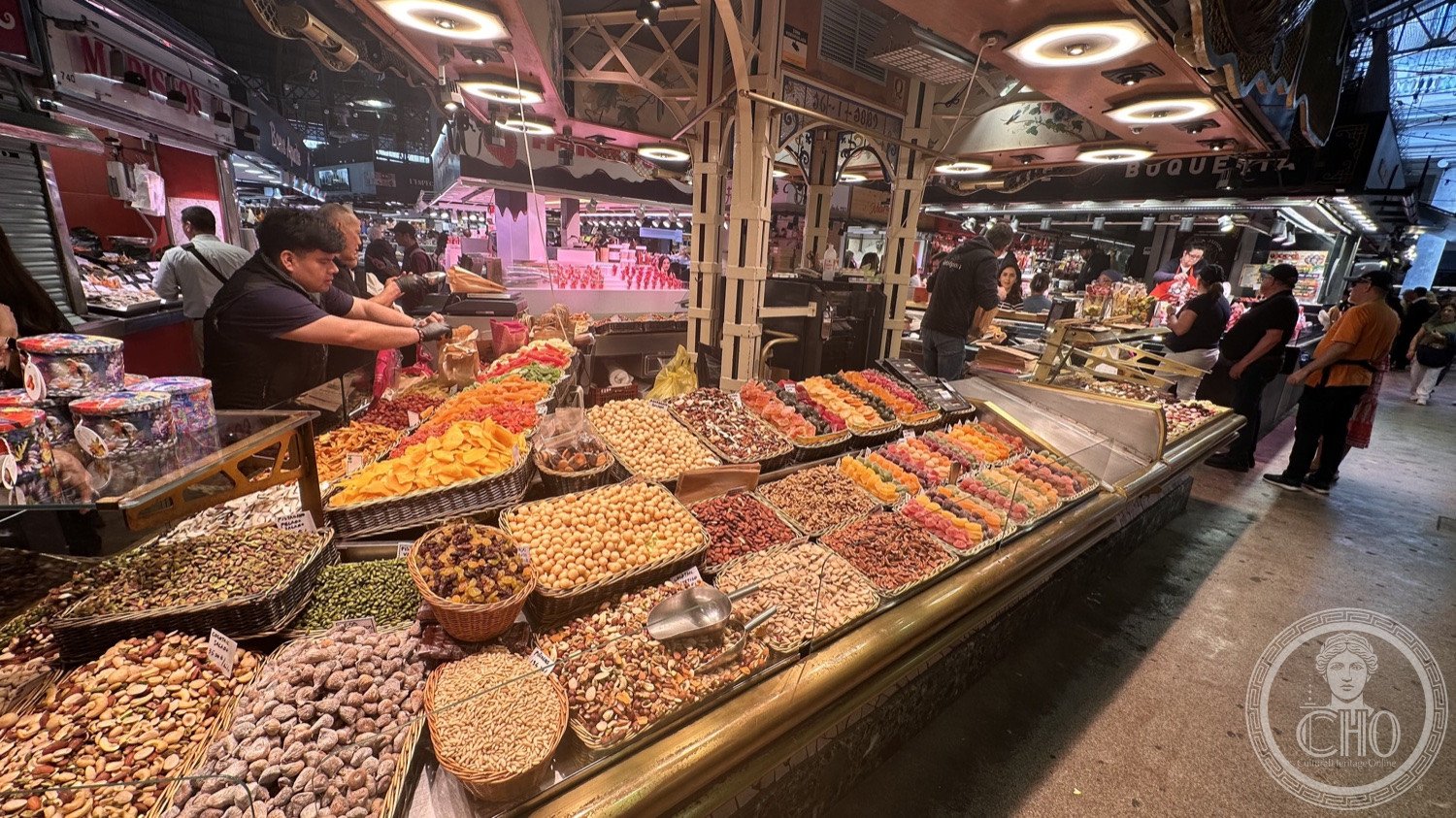 La Boqueria — Dried fruit and nuts heaped at a counter.