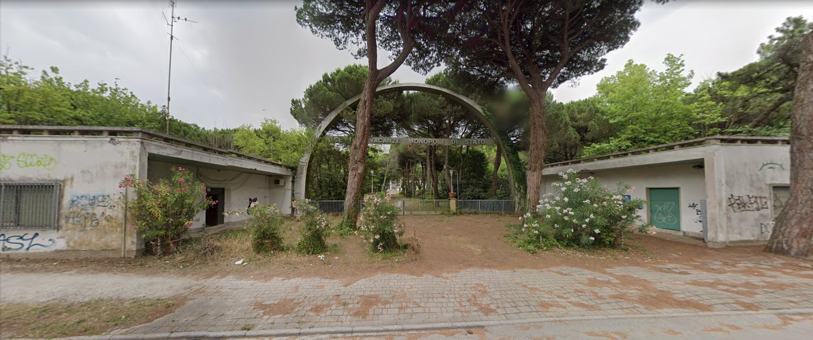 The entrance and tower of the ex Colonia Montecatini in the pine forest of Cervia