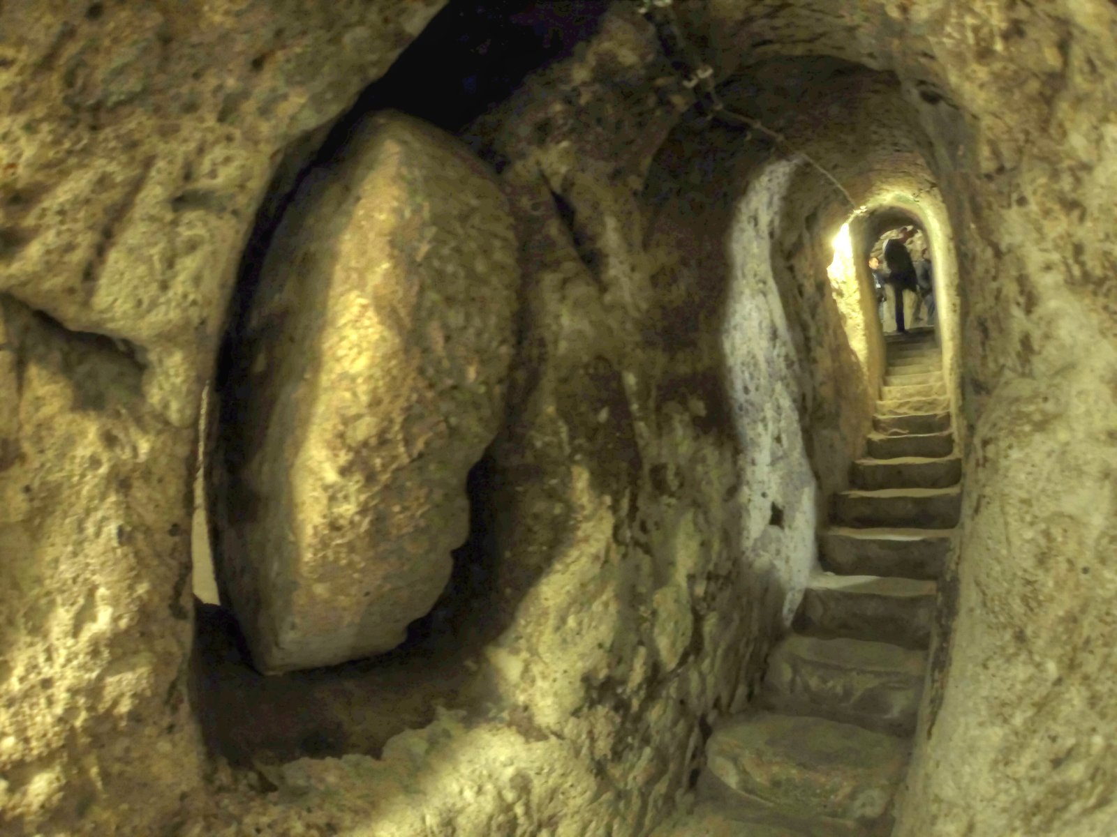 Carved stone tunnel corridor descending into the 18-level Derinkuyu underground city in Cappadocia