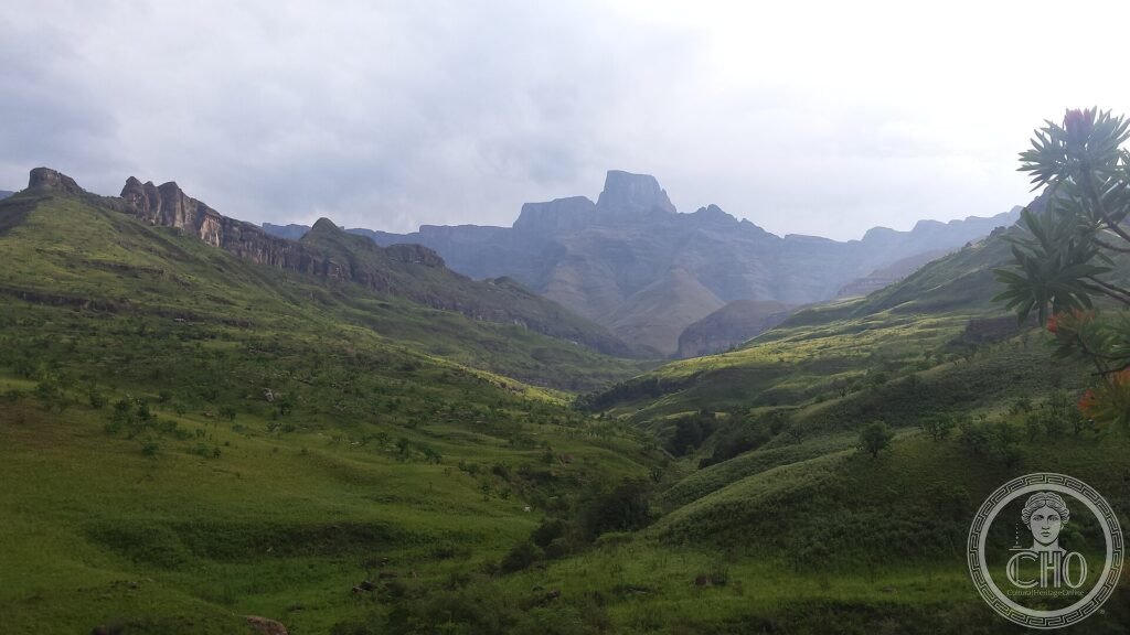 Green valleys below the dramatic basalt peaks and crags of the Drakensberg mountains