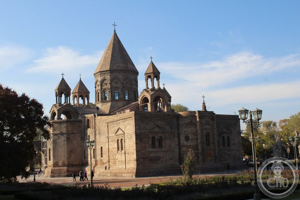 The grey stone Etchmiadzin Cathedral with its conical domes in Armenia