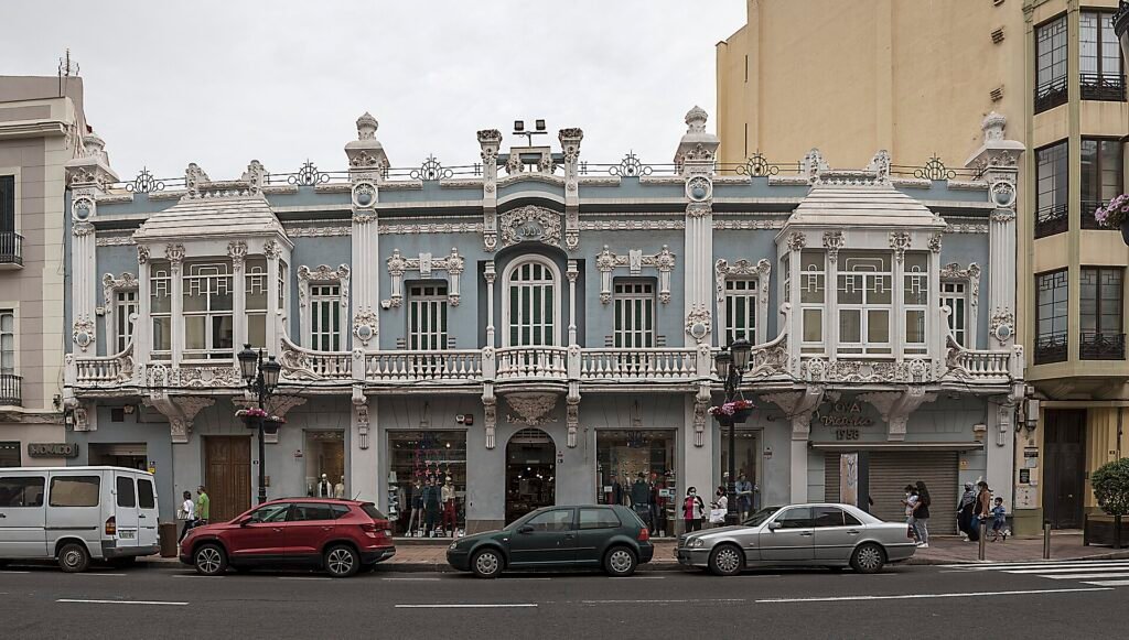 The Modernista façade of the Antiguo Economato Militar in Melilla, with floral panels and a balustraded top The Modernista façade of the Antiguo Economato Militar in Melilla, with floral panels and a balustraded top
