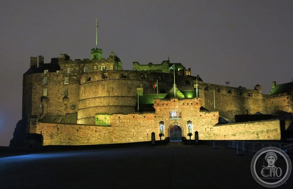Edinburgh Castle floodlit at night on its volcanic rock above the city