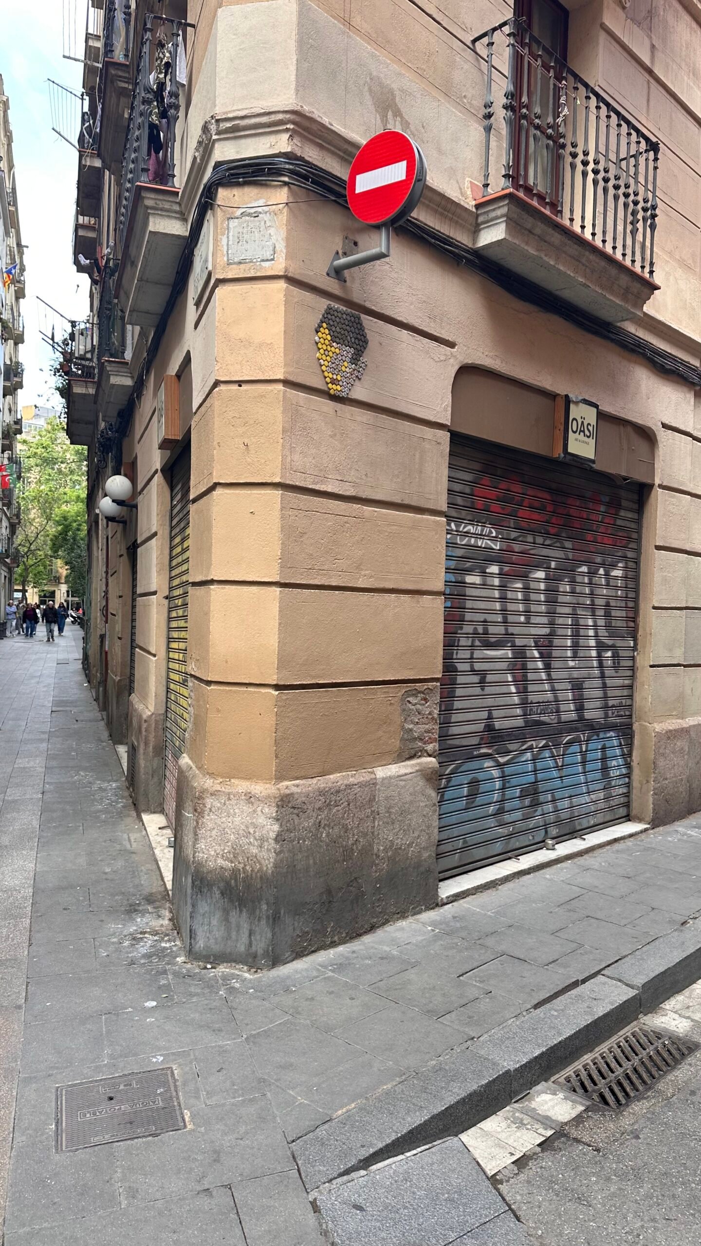 A Raval street corner with shutters covered in street art