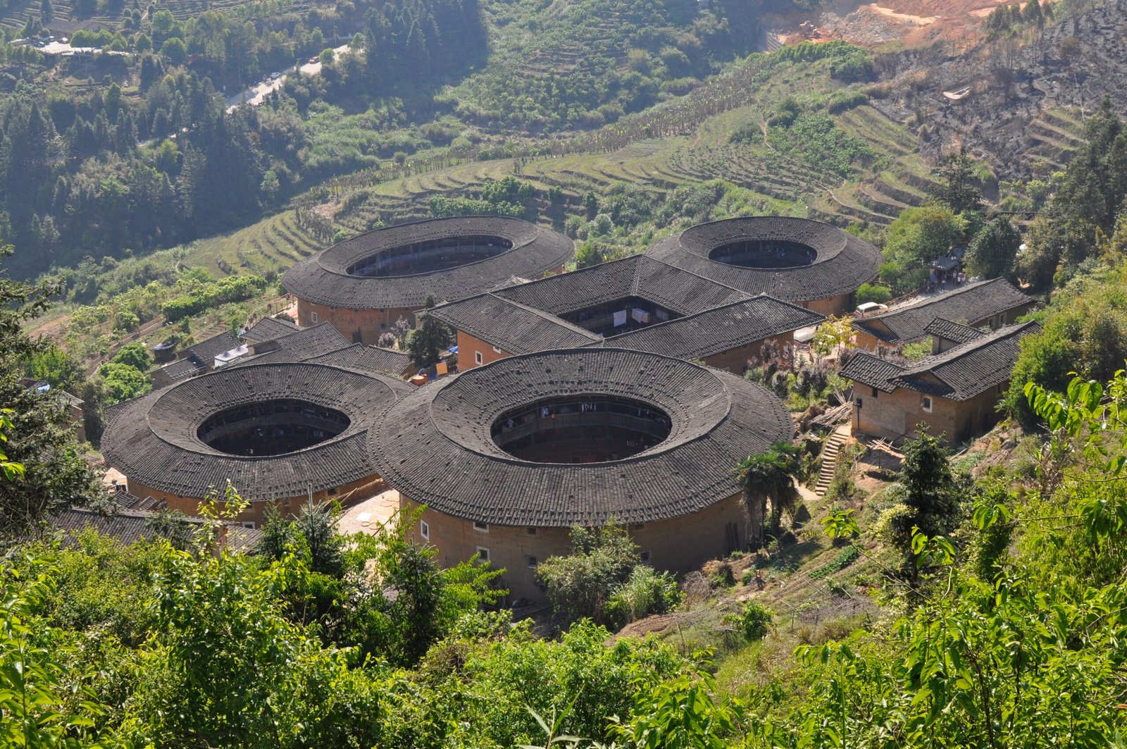 Tianluokeng Tulou Cluster showing one square building surrounded by four circular earthen tulou, Yongding Fujian China