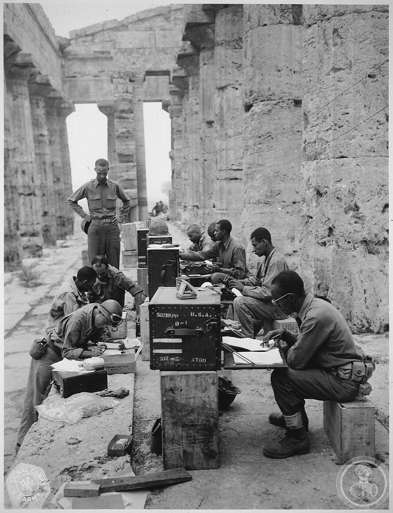 
"A company of men has set up its office between the columns (Doric) of an ancient Greek temple of Neptune, built about 