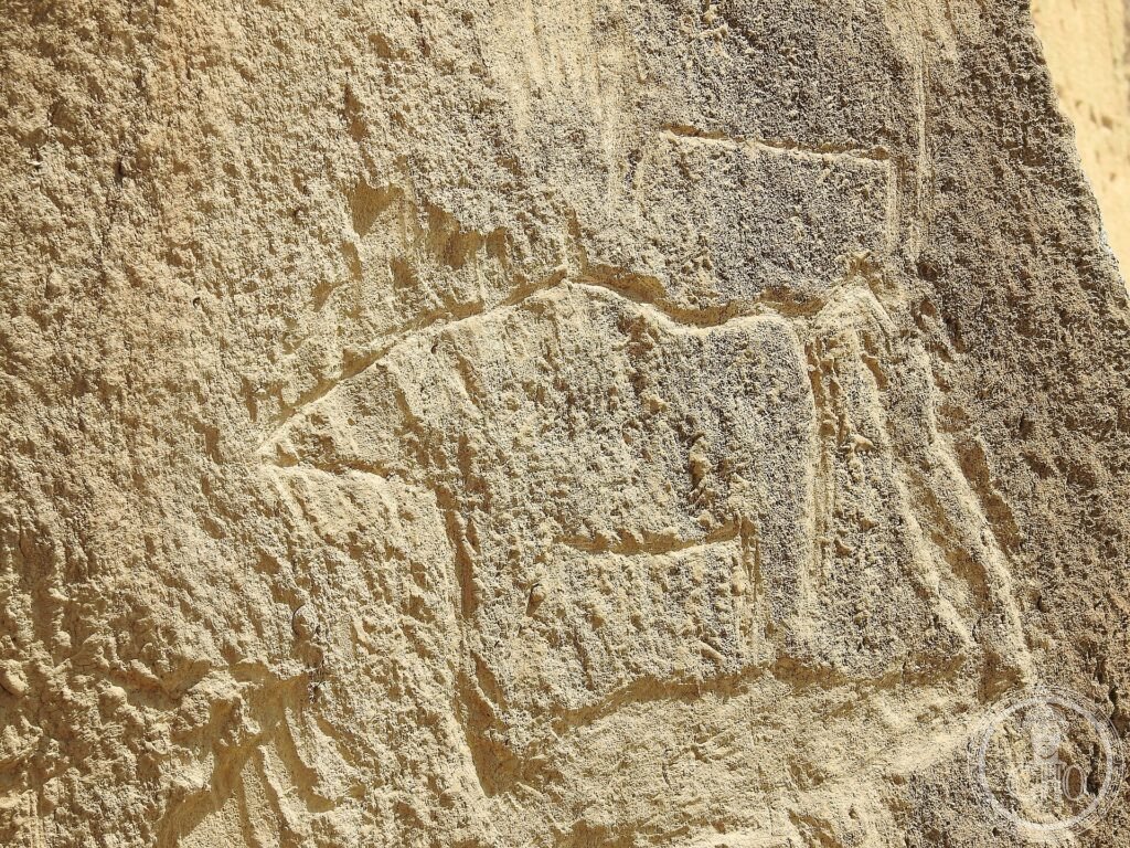 A prehistoric petroglyph of an animal carved into a rock face at Gobustan
