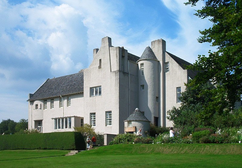 Grey harled walls and asymmetric chimneys of the Hill House at Helensburgh by Mackintosh