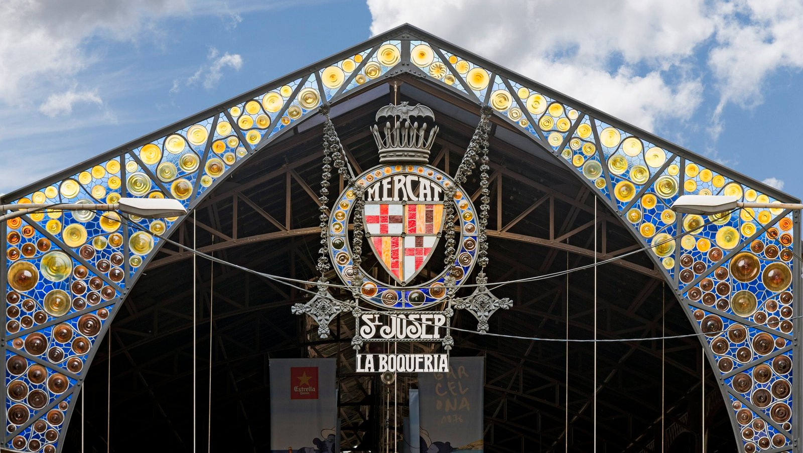 The Modernista iron entrance and stained-glass sign of La Boqueria market