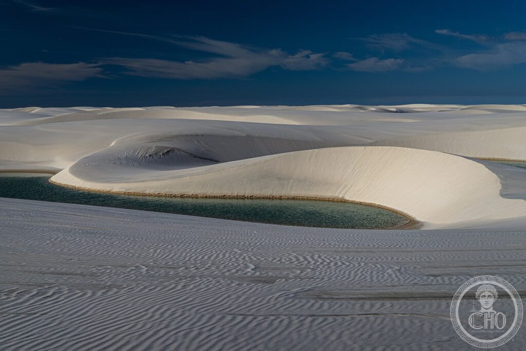 White sand dunes with turquoise rainwater lagoons stretching to the horizon at Lençóis Maranhenses