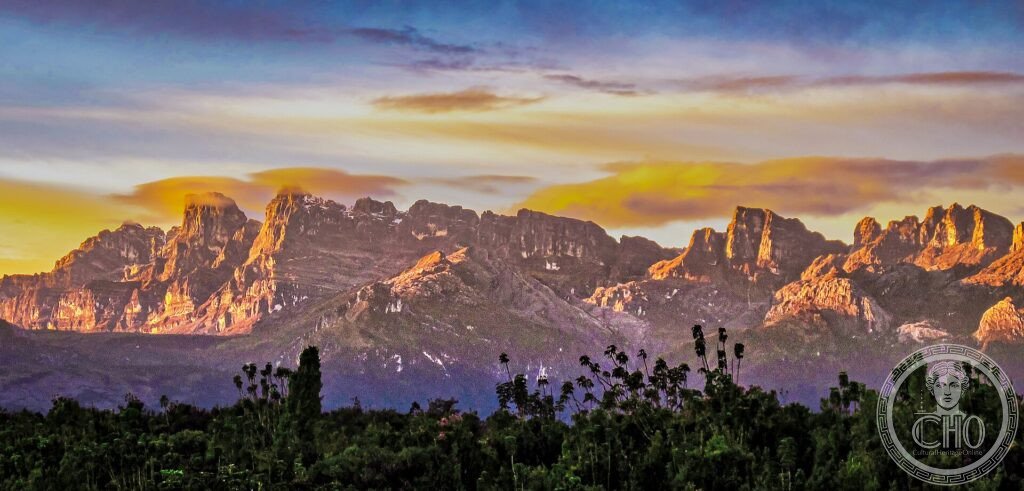 Jagged glaciated peaks lit by sunset above forest in Lorentz National Park, Papua