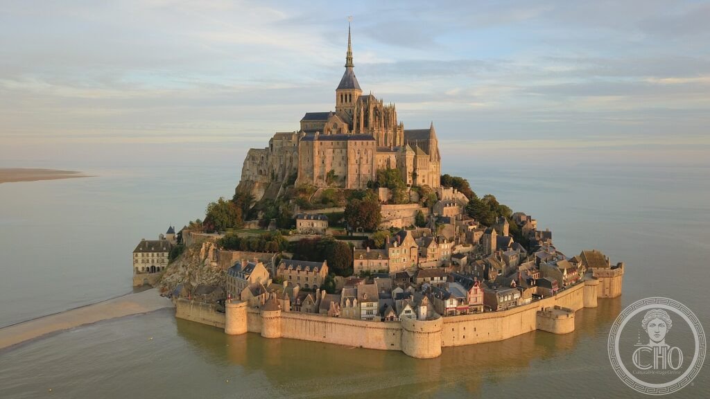 Mont-Saint-Michel abbey rising on its tidal island above the bay at golden hour