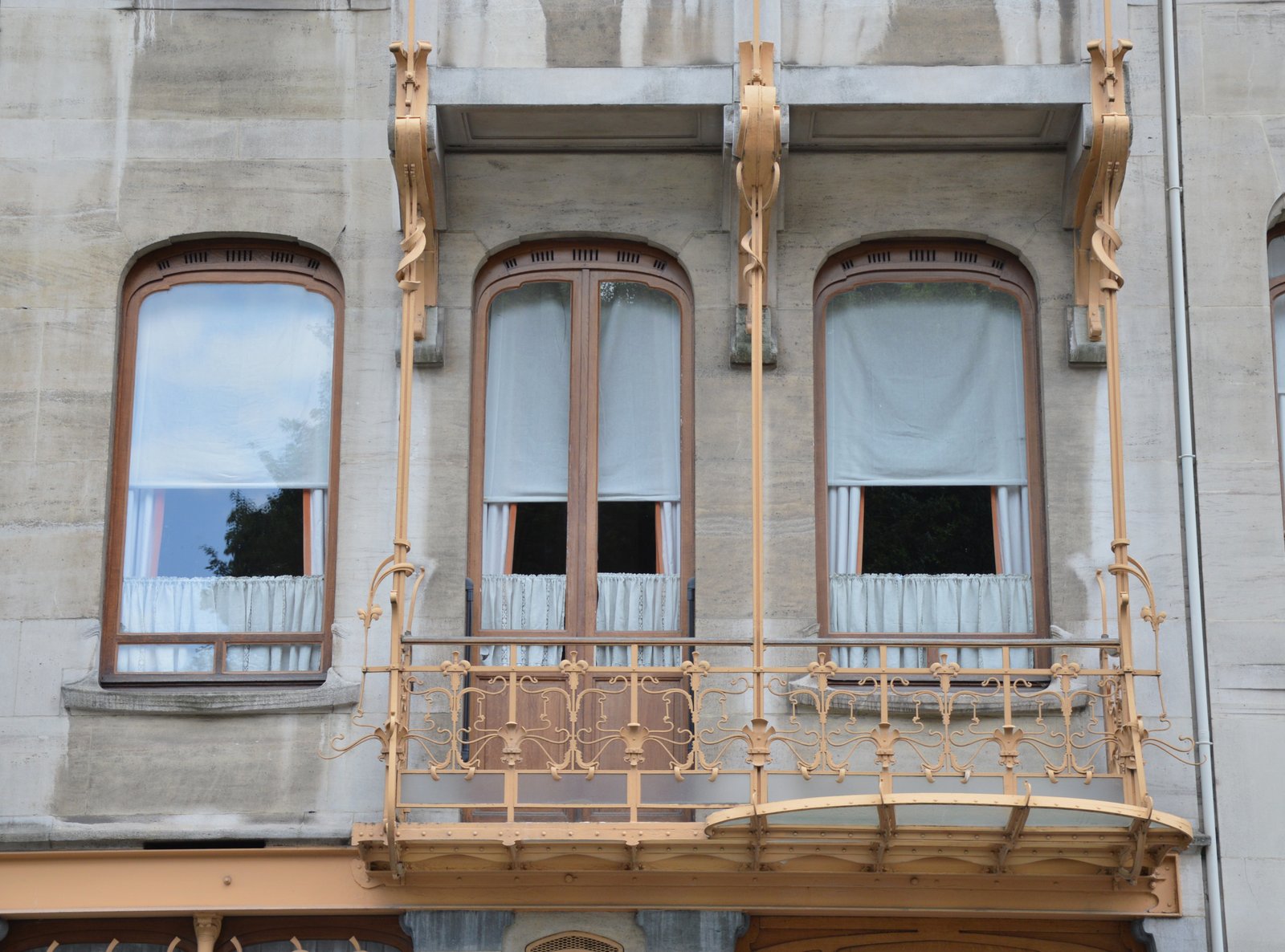 Gilded wrought-iron balcony and curved windows on the Horta house