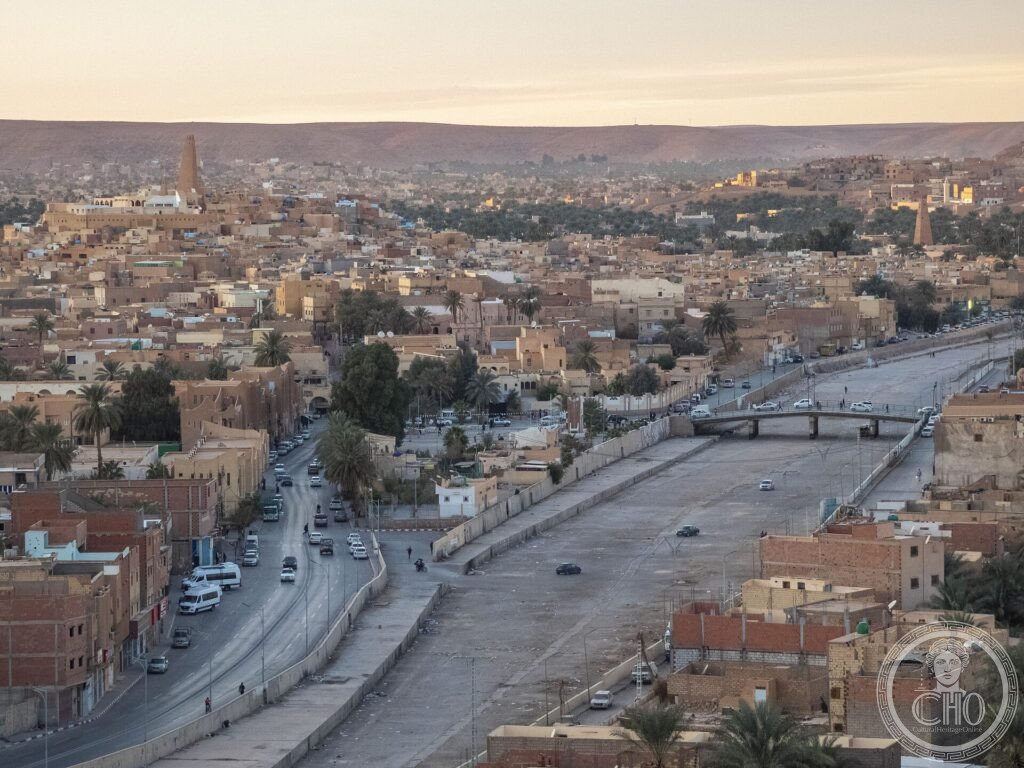 The terracotta town of Ghardaïa climbing a hill with a pyramidal minaret in the M'zab Valley