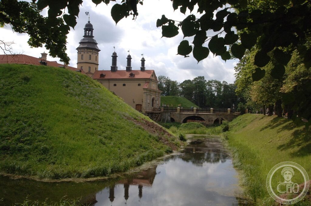 The palace of the Radziwiłł family at Nesvizh with its tower behind a moat and green ramparts
