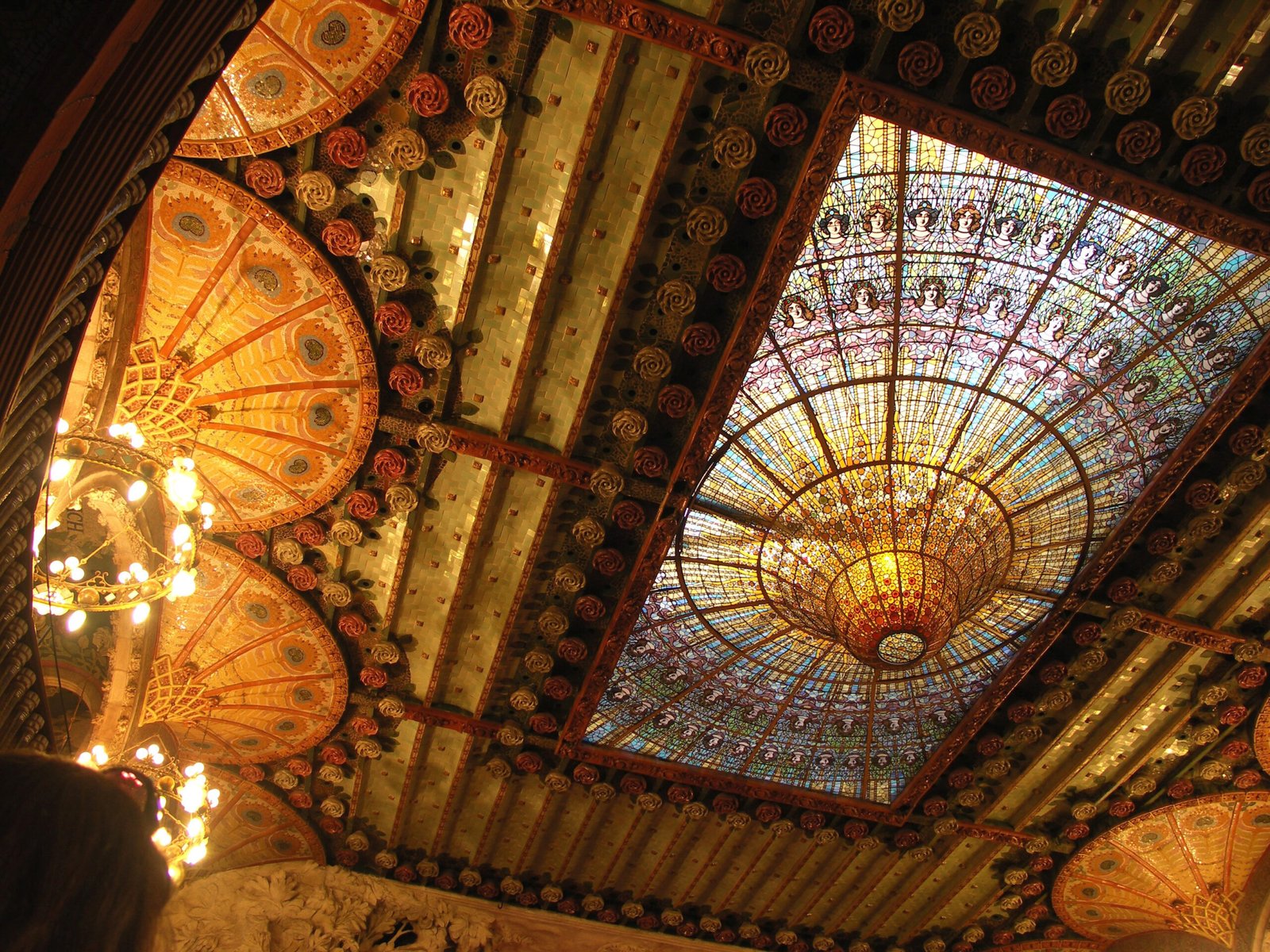 The inverted stained-glass skylight of the Palau concert hall, a golden sun of coloured glass