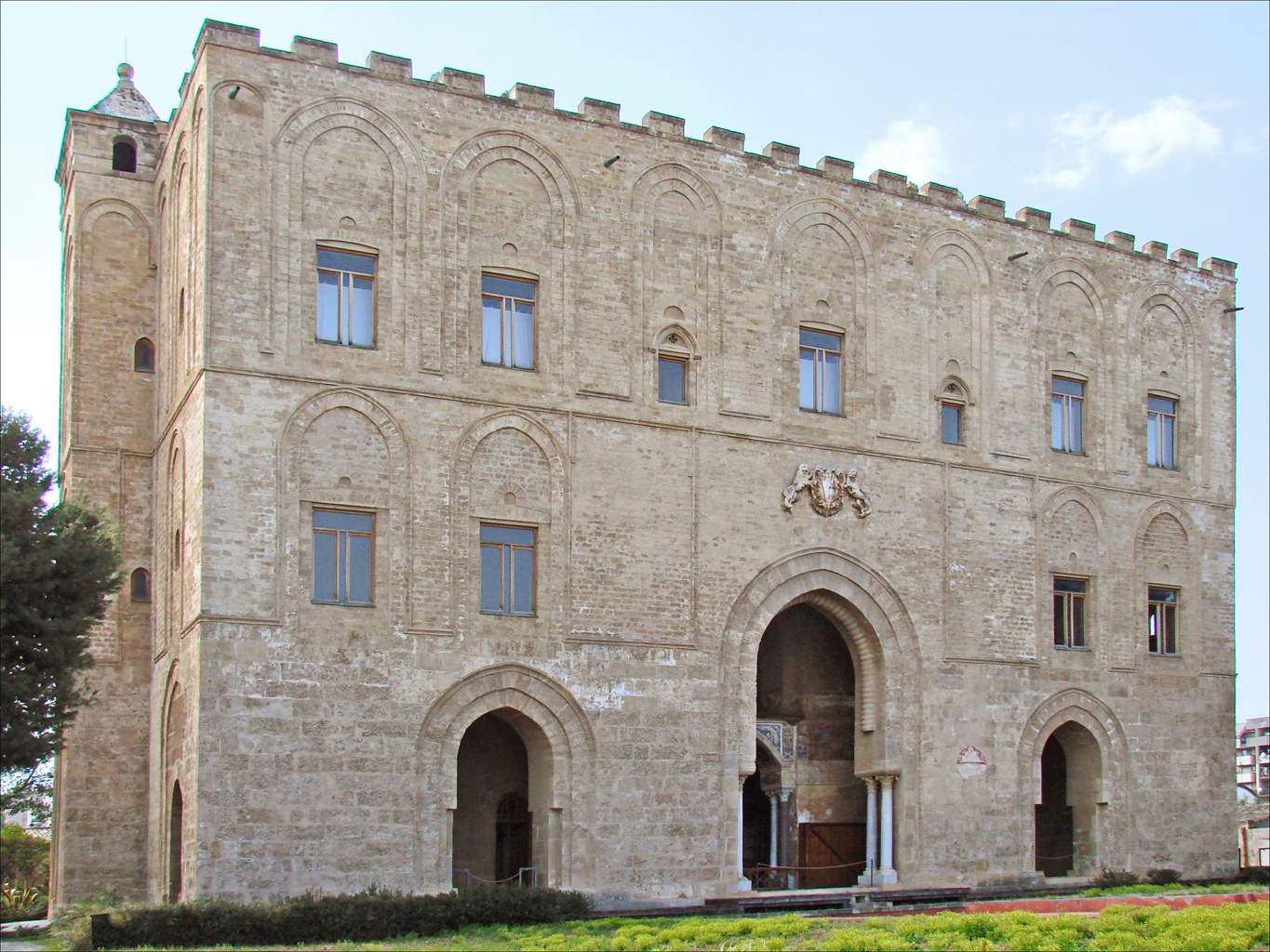 The north facade of La Zisa in Palermo seen from the garden, with blind arcades and merlons