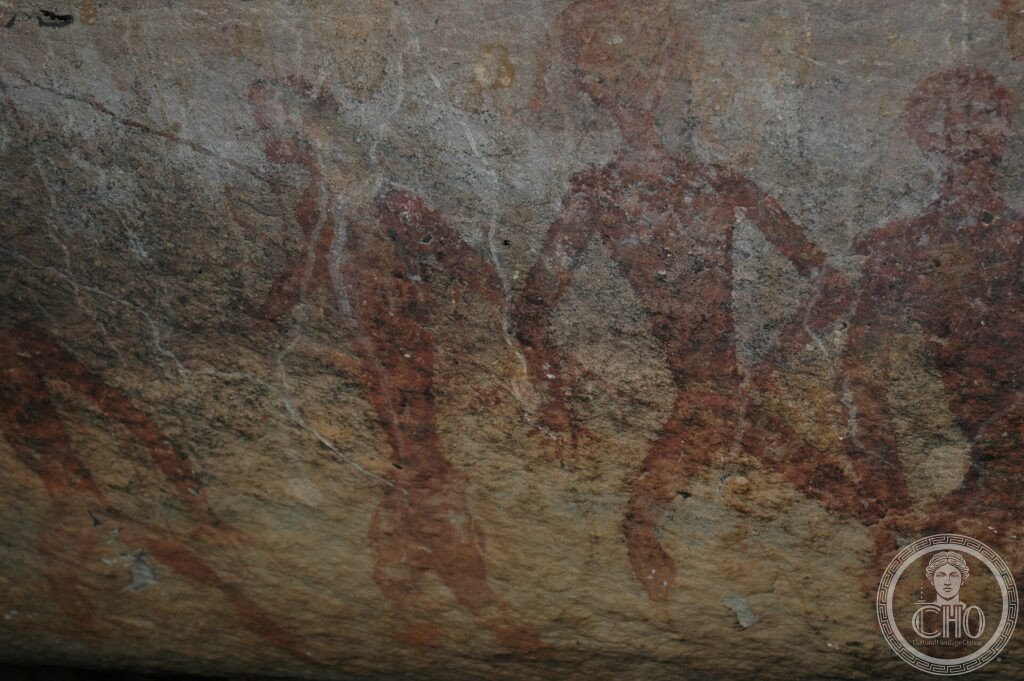Prehistoric red rock paintings of human figures on a stone surface at Phu Phra Bat, Thailand