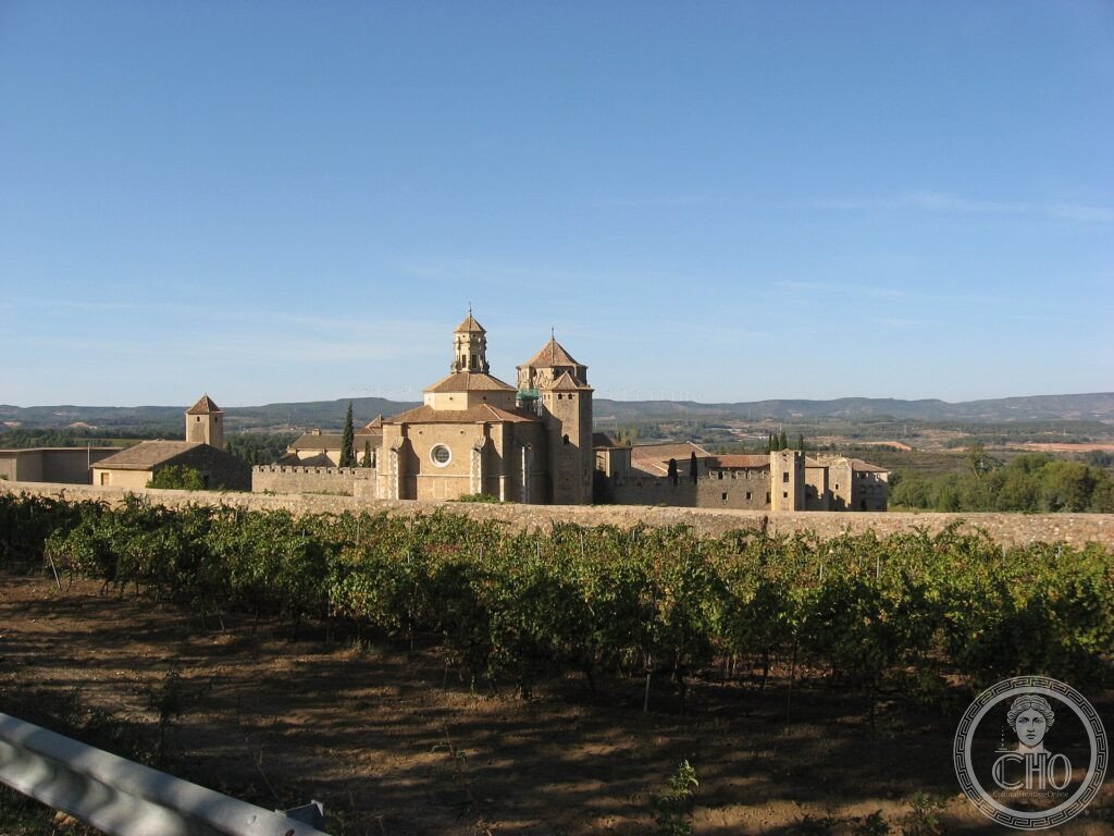 The walled Cistercian Monastery of Poblet with its church and towers among vineyards